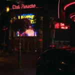 a car parked in front of a building at night