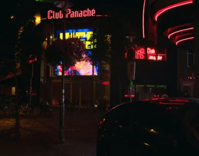 a car parked in front of a building at night