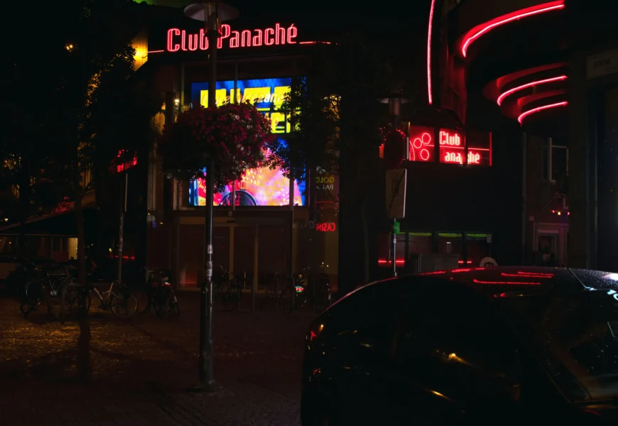 a car parked in front of a building at night