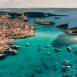 a group of boats floating on top of a body of water