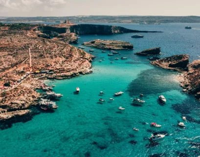 a group of boats floating on top of a body of water