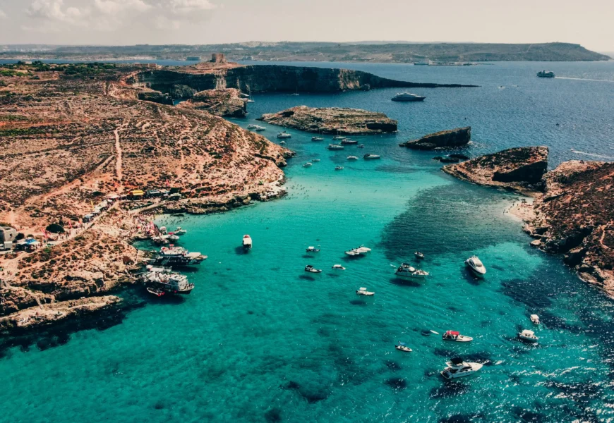 a group of boats floating on top of a body of water