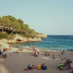 a group of people on a beach near the water