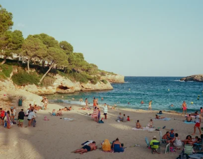 a group of people on a beach near the water