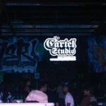 a group of people standing in front of a wall covered in graffiti