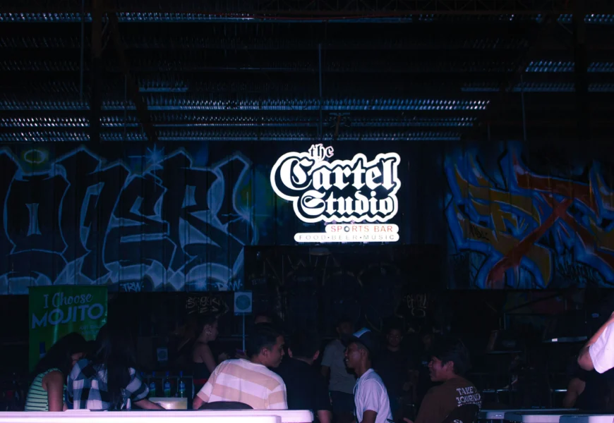 a group of people standing in front of a wall covered in graffiti
