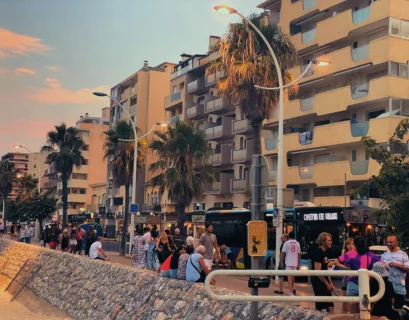 a group of people standing on the side of a road
