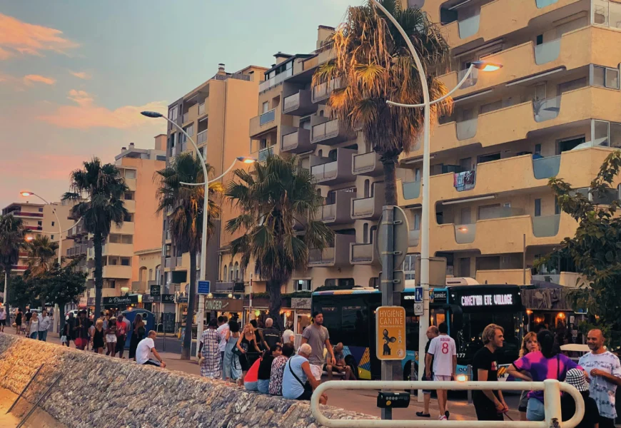 a group of people standing on the side of a road