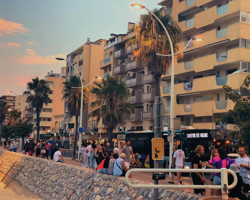 a group of people standing on the side of a road