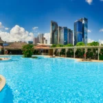 a large swimming pool with lounge chairs around it