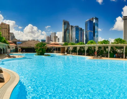 a large swimming pool with lounge chairs around it