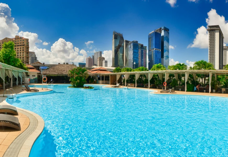 a large swimming pool with lounge chairs around it