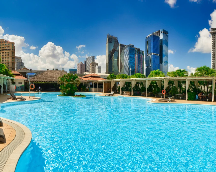 a large swimming pool with lounge chairs around it