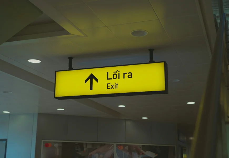 A yellow sign hanging from the ceiling of a building