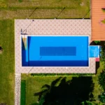 an aerial view of a house with a swimming pool
