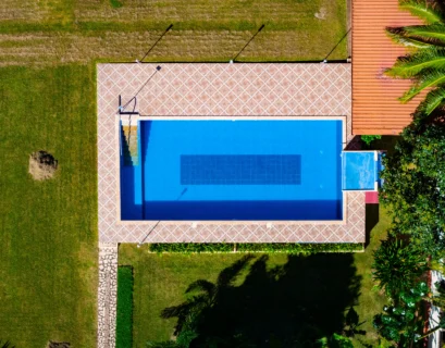 an aerial view of a house with a swimming pool