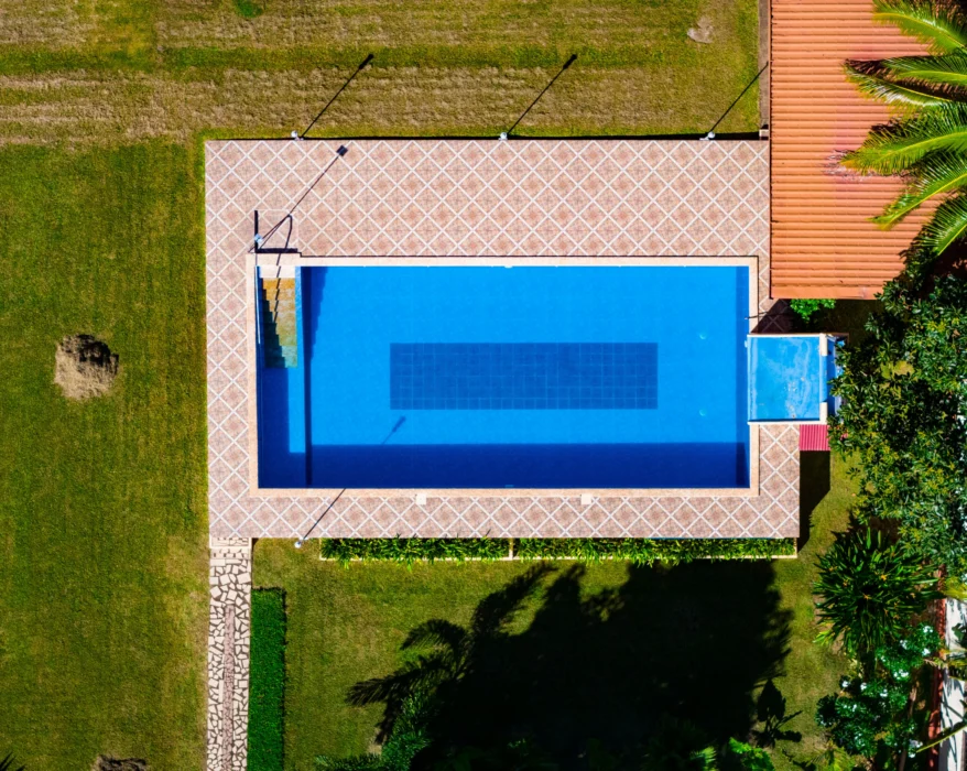 an aerial view of a house with a swimming pool