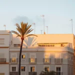 Buildings are bathed in golden hour sunlight.