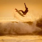 man surfing on sea waves during daytime