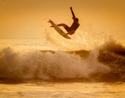 man surfing on sea waves during daytime