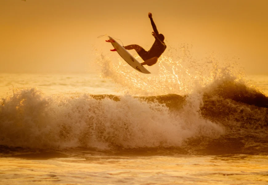 man surfing on sea waves during daytime