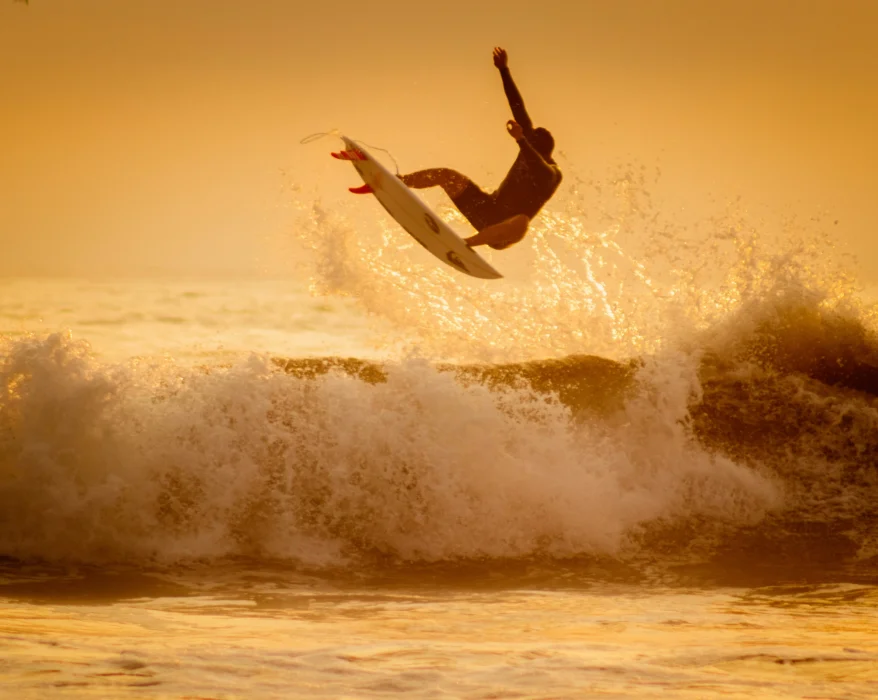 man surfing on sea waves during daytime