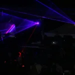 three blue stage lights inside black room