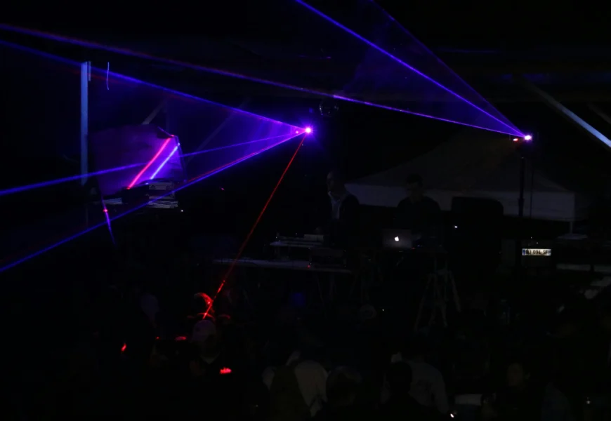 three blue stage lights inside black room