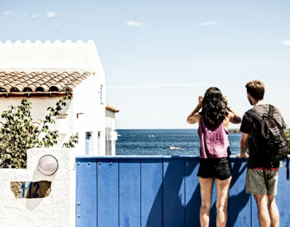 woman in pink and black tank top and blue denim shorts standing on blue metal railings